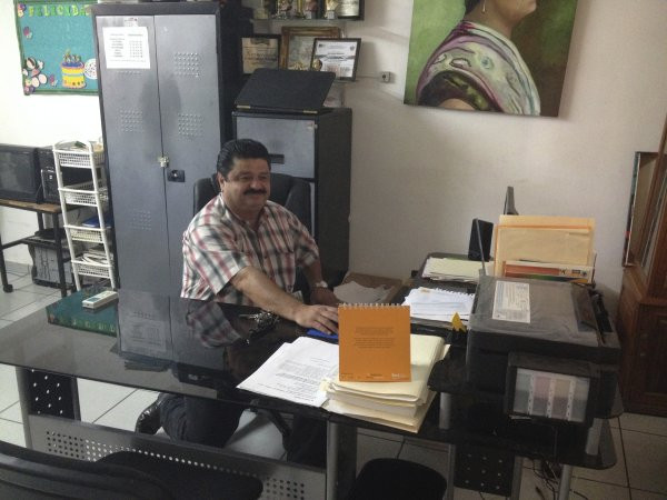 Principal Carlos Beatriz at his desk